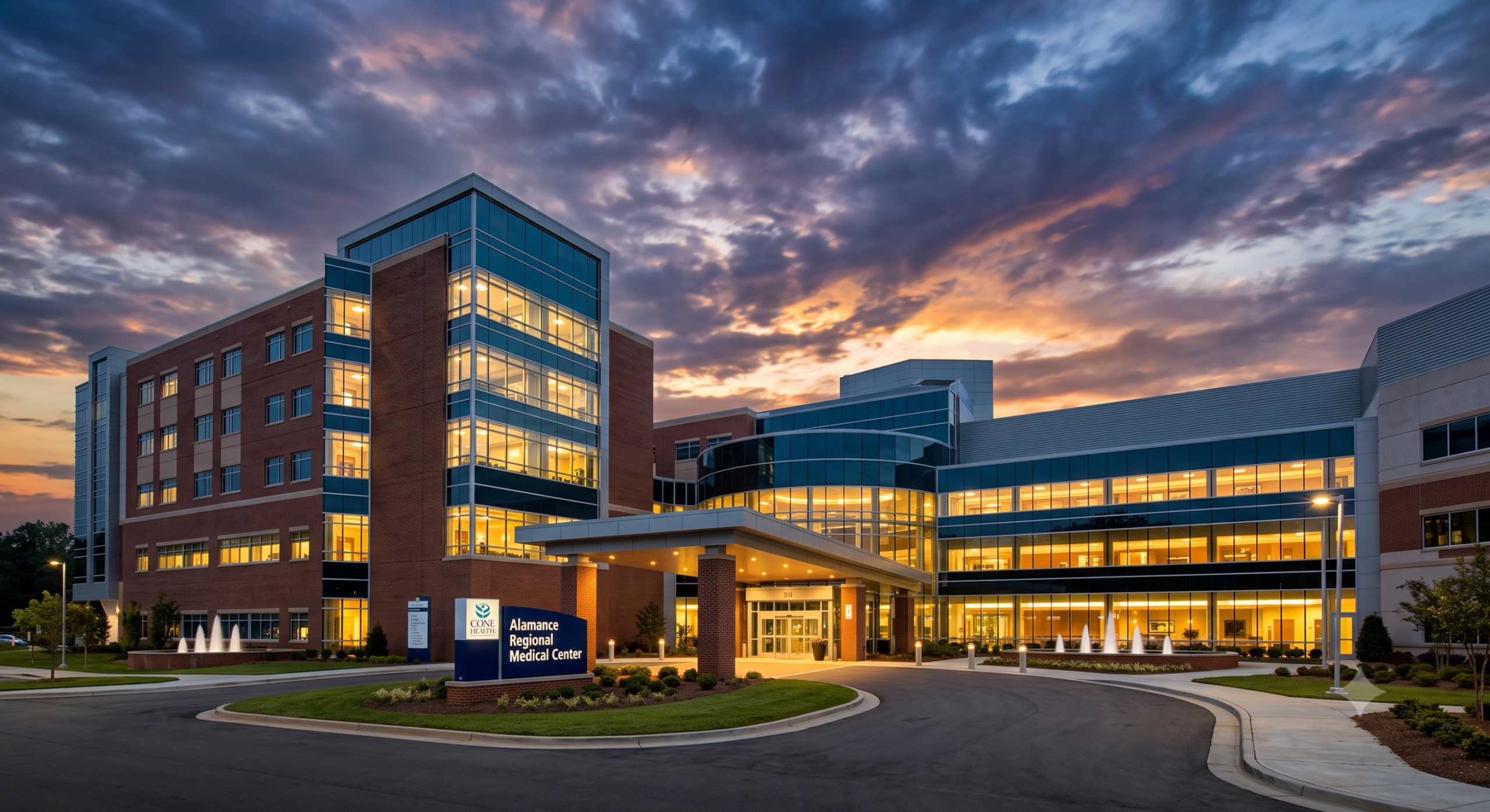 Alamance Regional Hospital image shows large building with beautiful sky with sun setting overhead