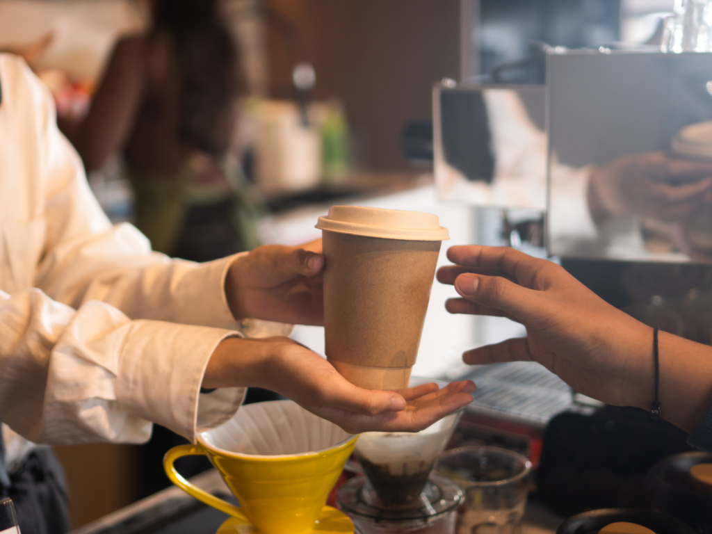 Person getting coffee at a Burlington, NC Coffee shop
