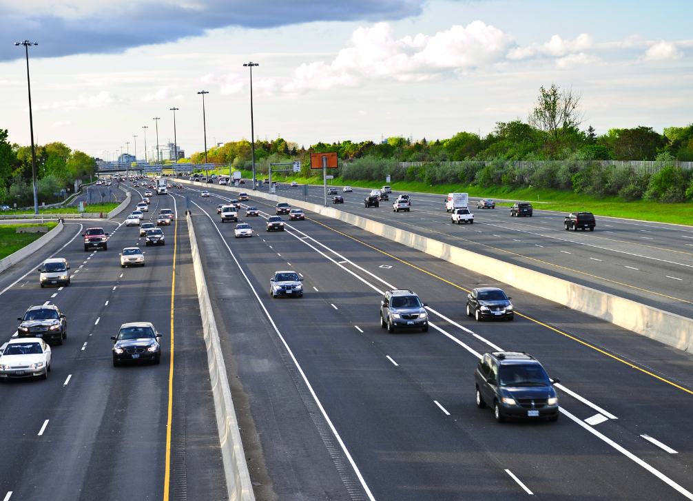 Image shows busy freeway with cars and trucks commuting to work